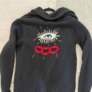 Raquel Allegra Black Sweater with Eye and Red Rings Design